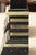 This is a handsome pair of Egyptian Revival obelisks crafted in black stone and richly decorated with brass and mother-of-...