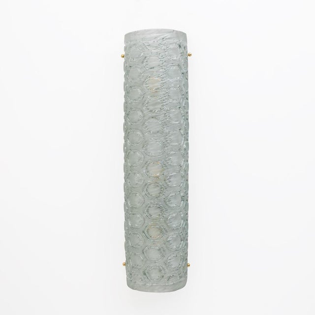 Pair of vertical and cylindrical appliques in light green Murano glass, textured glass with honeycomb workmanship. The...