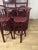 Bamboo, wicker, and glass bar unit, consisting of a wall unit, a backless stool, two stools with backrests, and a burgundy...