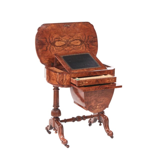 This antique early victorian 19th century inlaid burr walnut writing or sewing table is an exquisite example having a...