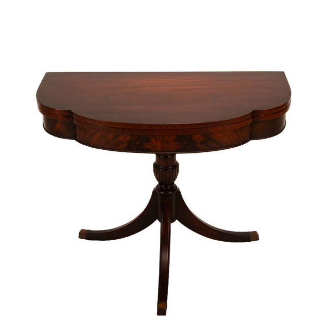 Here is a gorgeous mahogany flip top card table. The table top rotates 90 degrees, allowing for a base to hold the table...
