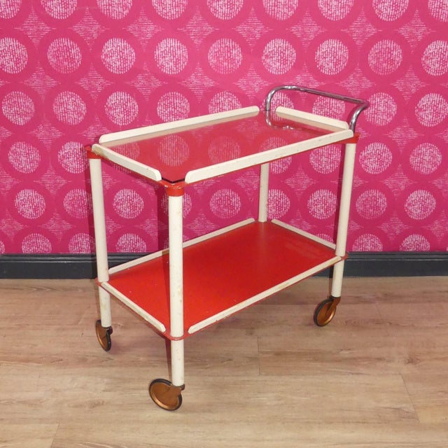 Smaller, finer Bar or tea cart Filigree wooden frame, red shelves, a glass plate on the top for protection. Without a...