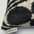 "Woven from premium silk velvet by Turkish &amp; Uzbek artisans Bold black circle and wave motif on soft ivory background...