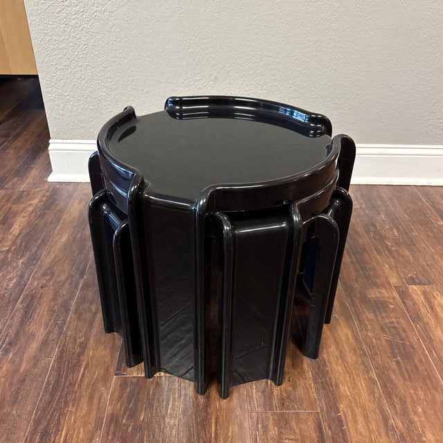 Black plastic Kartell tables designed by italian architect Giotto Stoppino. These tables can be arranged in a variety of...