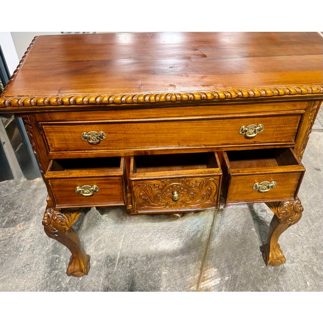 This piece serves as both a functional storage and a formal statement piece for traditional interiors. It is a classic...