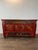 An antique Northern Chinese/Mongolian red lacquered cabinet. This exquisite cabinet features a vibrant red lacquered...