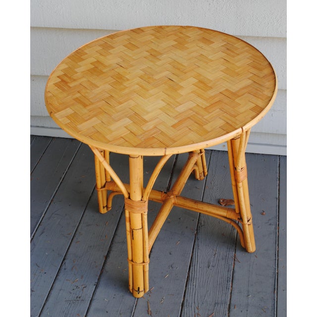 This vintage 1960's round accent table has a woven top. It could make a small dining table or a side table for most any...