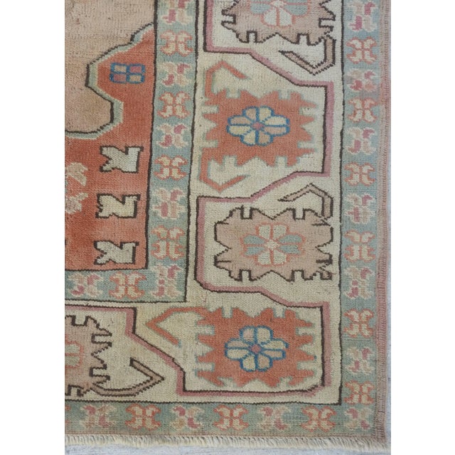 Soft hues of neutrals, flesh tones and blues form this lovely hand-knotted Oushak rug which was made in the early 20th...