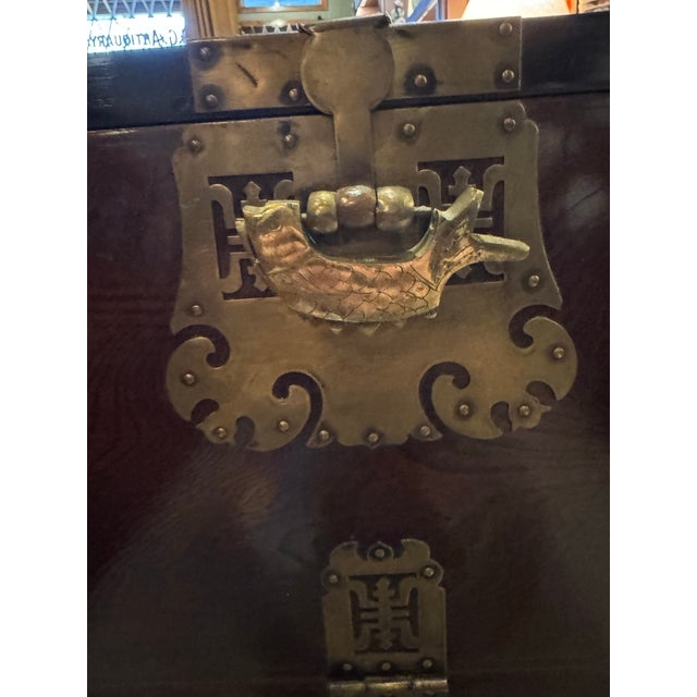 A beautifully preserved Korean bandaji chest, crafted from rich elmwood and adorned with intricate brass hardware...