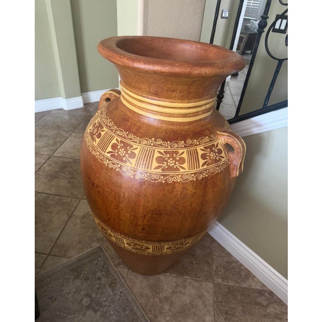 Beautiful oversized decorative floor pot featuring a warm terracotta/rust finish with cream and gold-toned floral and...