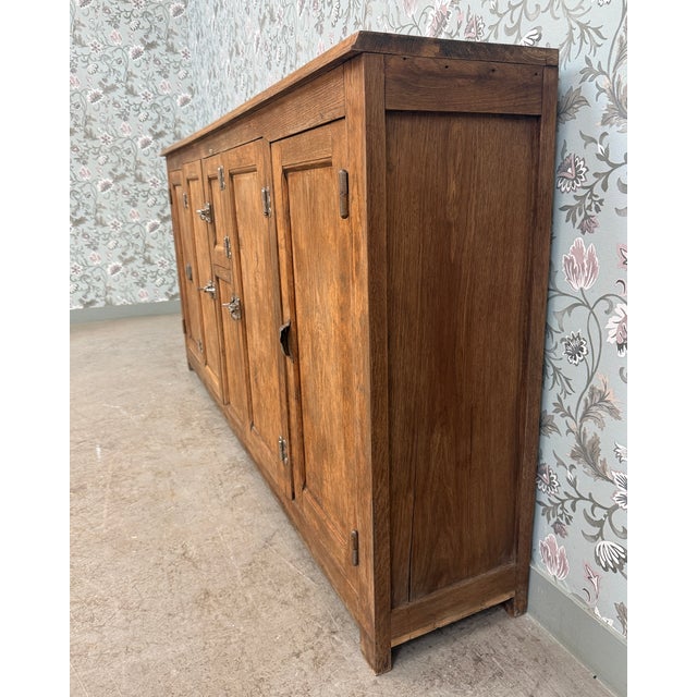 With its imposing silhouette and unique history, this antique solid oak bar icebox is a rare piece from early 20th-century...