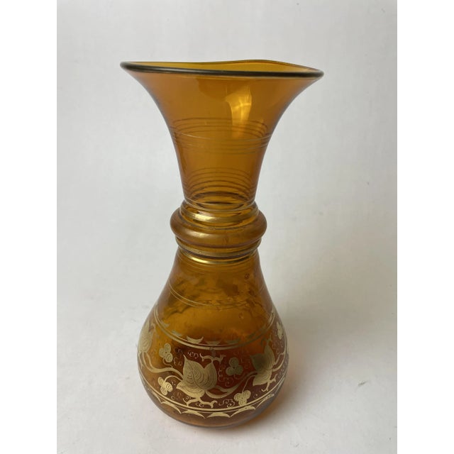Blown glass vase decorated with gold leaf.