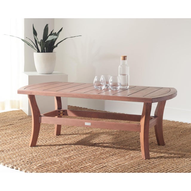 The finely carved curves and angles of the Payden Outdoor Coffee Table lend rich classic-contemporary charm to any outdoor...