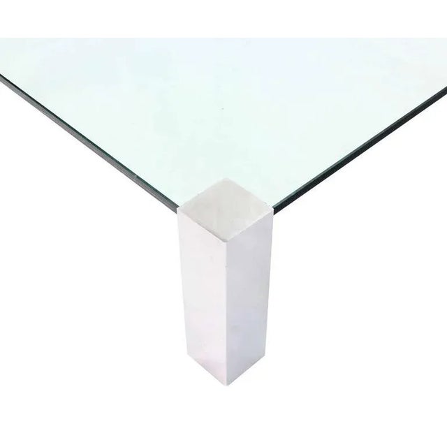 Very nice square coffee table with thick glass top and chrome legs. Made in the mid 20th century.