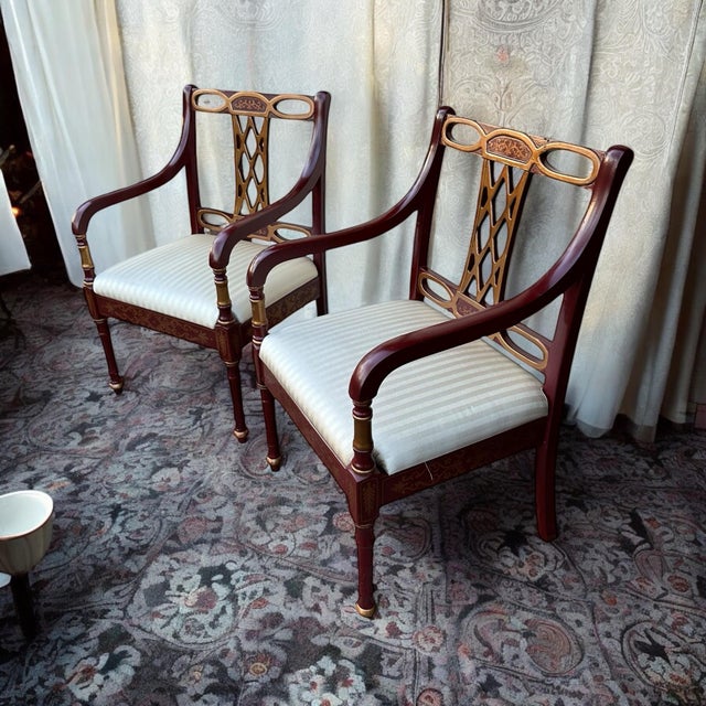 A vintage pair of Chinoiserie glossy deep red and gold side chairs with fretwork designed backrests. Beautiful asian...