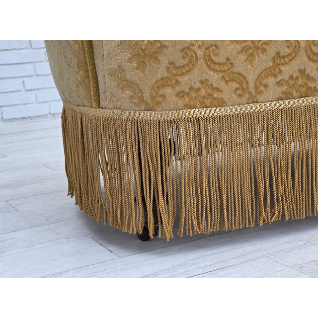 1950s, Danish 2-seater sofa. Green/honing furniture velour, beech wood legs, brass wheels on the front legs. Brass springs...