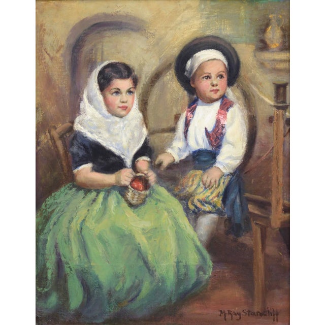 Mid century portrait of two children, a young boy and girl in traditional dress, set in a rustic interior by M. Ray...