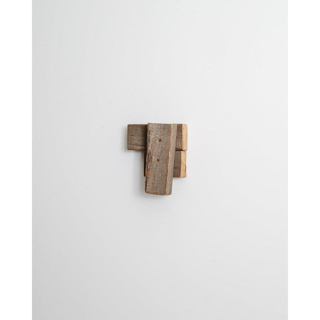 A rare decorative contemporary "untitled" wooden wall sculpture artwork by the american artist richard nonas produced in...