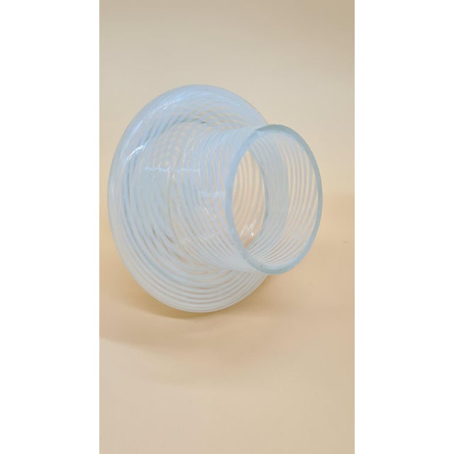 The Murano vase was created using the reticello technique and is an example of Italian glassmaking craftsmanship from the...