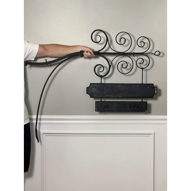 Two-tier wooden sign on a large, hand-forged wrought iron scrolled wall bracket, early 20th century. From idyllic Bucks...