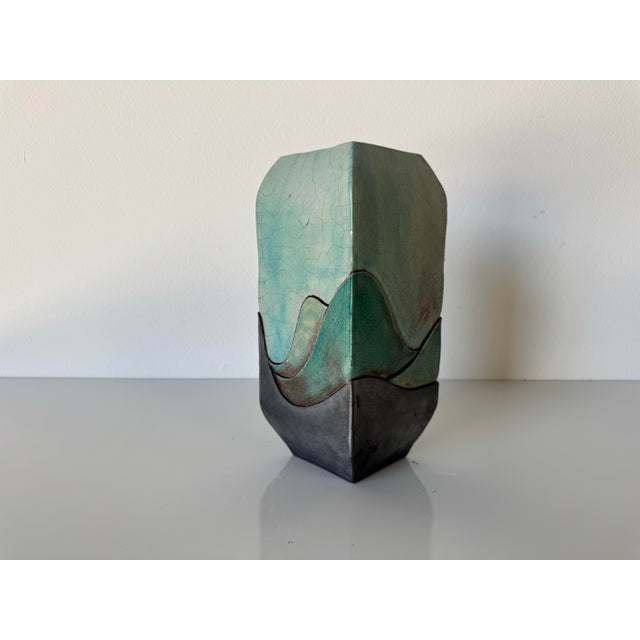Striking vintage studio pottery vase showcasing a unique angular form with a sculptural, geometric profile. The body...