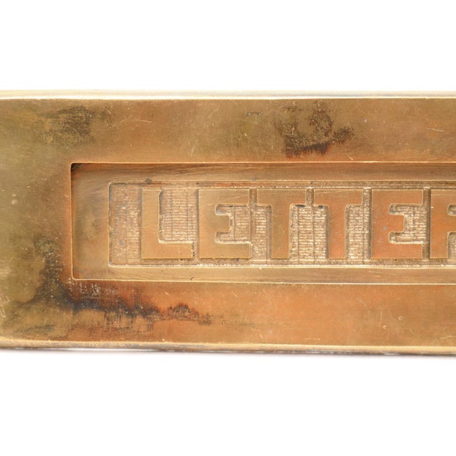 Vintage brass spring loaded mail slot that opens inward at 45 degrees to allow mail through. This is the cover plate only....