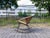 Elegant modernist rocking chair from the 1960s, handcrafted in woven cane and wicker. The organic, sculptural seat is...