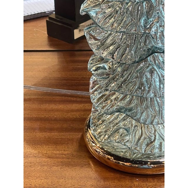The product is a pair of Murano glass ruffle lamps in a Fontana green color. These lamps are intricately designed with a...
