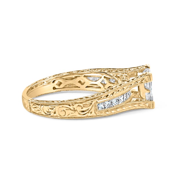 Immerse yourself in the timeless elegance of this 14K yellow gold engagement ring, where artistry meets brilliance. Four...