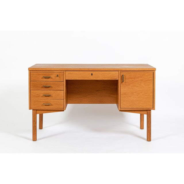This vintage mid century Danish modern oak wood desk was made in Denmark circa 1960. The desk has a classic Scandinavian...