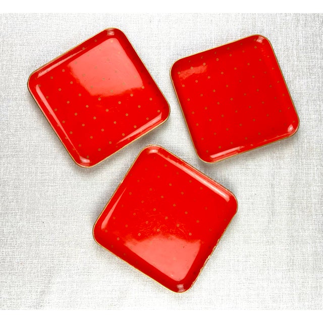 A nice set of mid century era hand painted Japanese lacquer trays in vivid red with gold edge and floral decoration. Made...