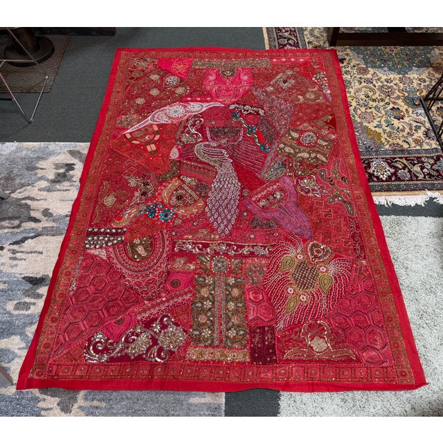 Design Plus Gallery presents an Indian Tapestry Artwork with Bead Embellishments. The fabric is a cherry red tone and has...