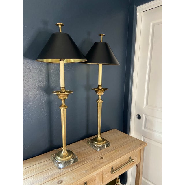 Illuminate your space with this gorgeous pair of vintage brass buffet lamps with lucite bases. These mid-century modern...