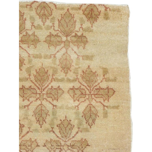 This mid-20th-century Turkish Anatolian throw rug presents an elegant allover botanical design across a warm ivory and...