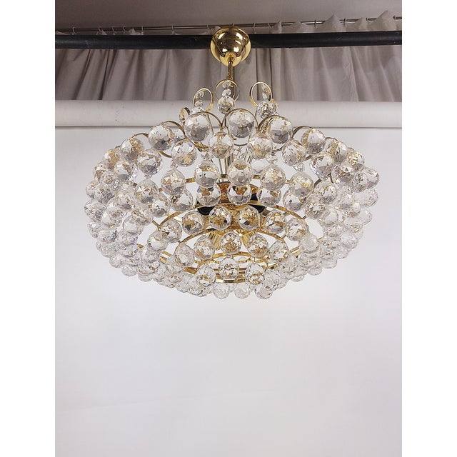Joski Bodemais crystal chandelier from the 70s, A highly decorative lamp made of crystal glass and gilded brass. with its...