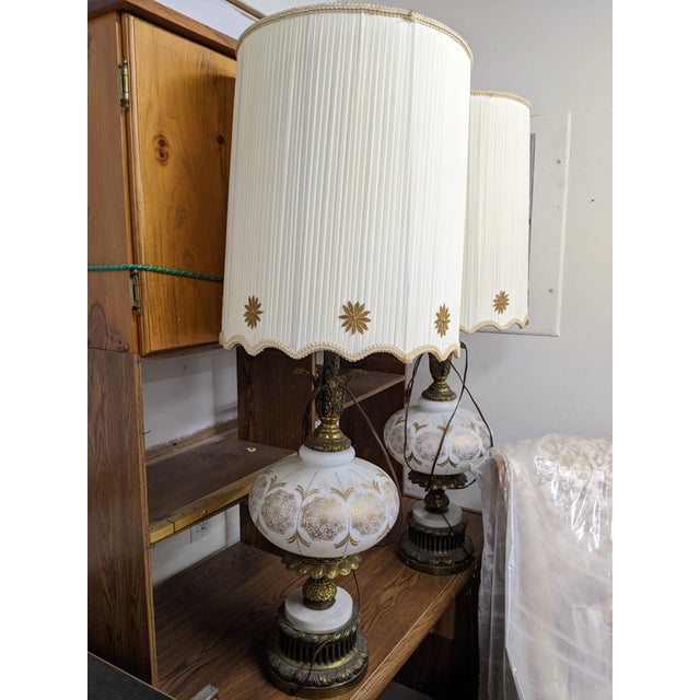 Beautiful pair of vintage lamps, passed down through four generations. White glass body with gold patterns. Base is marble...