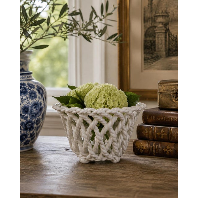 An elegant trompe l'oeil porcelain cachepot crafted in the form of a handwoven rope basket. Executed in glossy white...