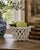 An elegant trompe l'oeil porcelain cachepot crafted in the form of a handwoven rope basket. Executed in glossy white...