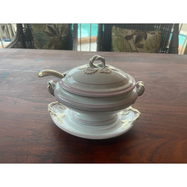 Here is a small tureen or gravy boat with a lid, under-plate and ladle, possibly associated with the historical china...