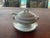 Here is a small tureen or gravy boat with a lid, under-plate and ladle, possibly associated with the historical china...