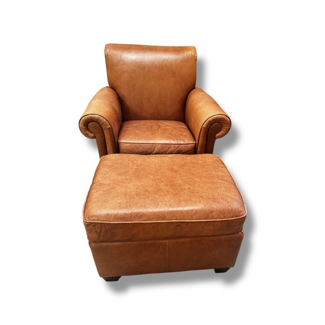 A timeless Bernhardt chair and matching ottoman upholstered in rich cognac leather that has developed a beautiful natural...