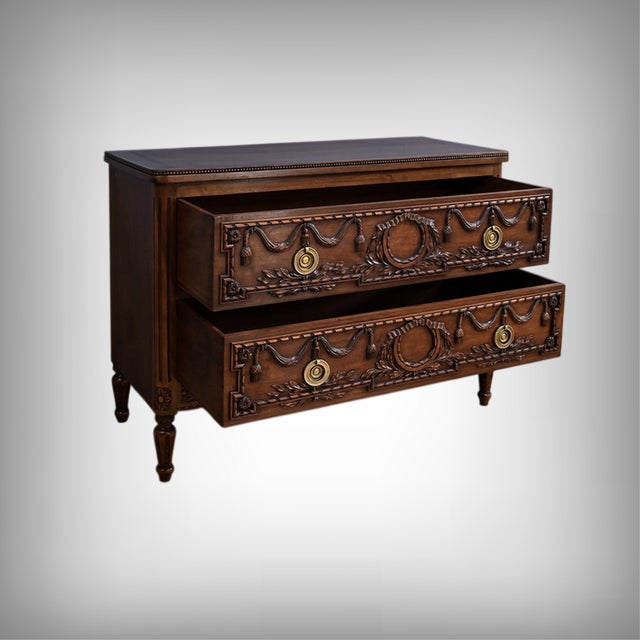 This elegant carved walnut chest of drawers, crafted in the Louis XVI style in the mid-20th century, embodies the...