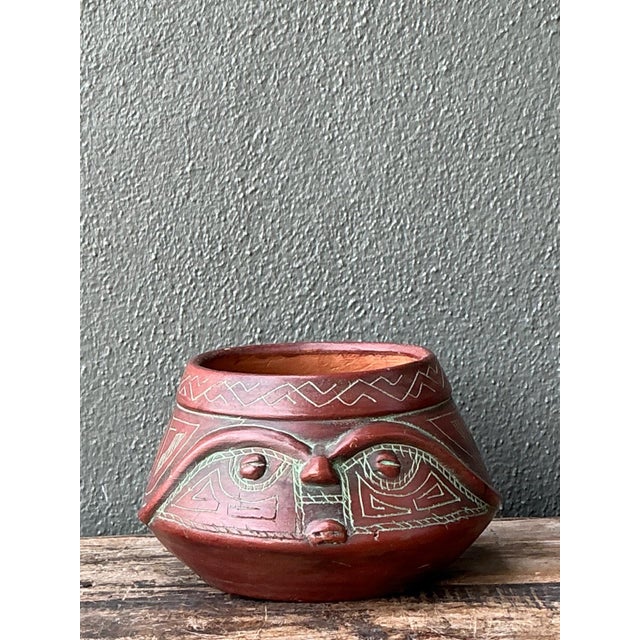 This vintage handcrafted ceramic bowl celebrates traditional craftsmanship through its expressive tribal-inspired design...