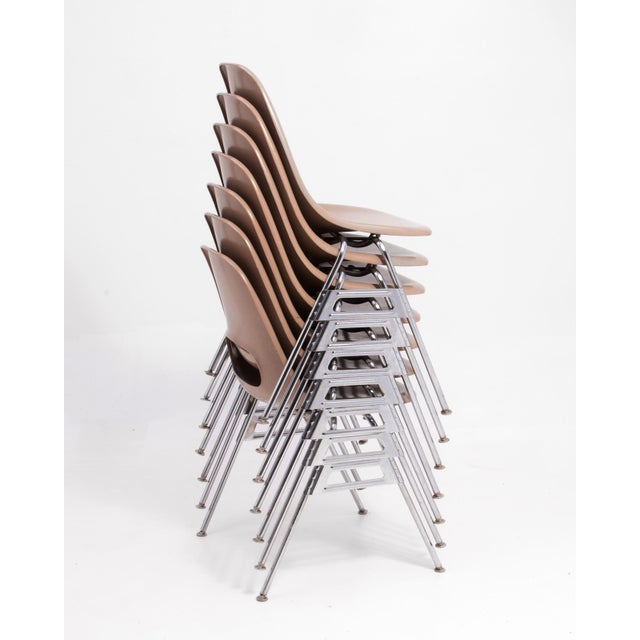 A set of seven Mid Century Krueger Metal Products Fiberglass stacking chairs after the design of Charles and Ray Eames....