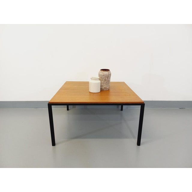 Vintage modernist coffee table of the 60s, square teak tray, black metal base, in the style of the Tables of Florence...