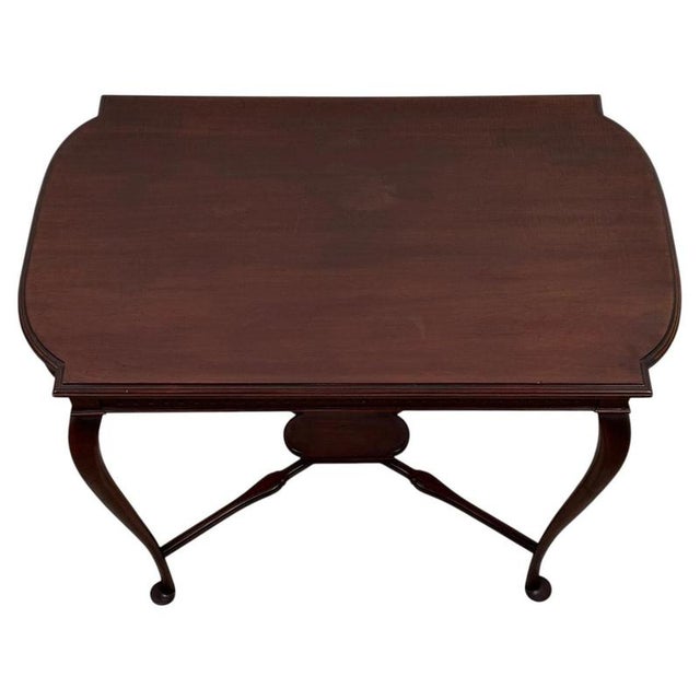 A handsome early 20th-century English side table, finely crafted from mahogany and distinguished by its elegant cabriole...
