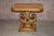 Vintage accent table with pedestal has a neoclassic style. The table is made of wood and has an inlaid burl top. The...