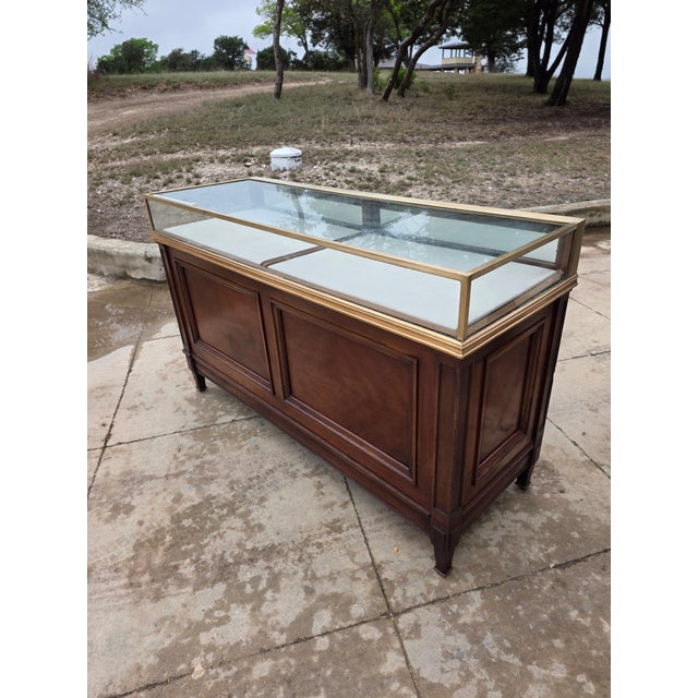 Beautiful antique counter with glass and polished bronze top that can be removed. The glass is worn . This makes a great...