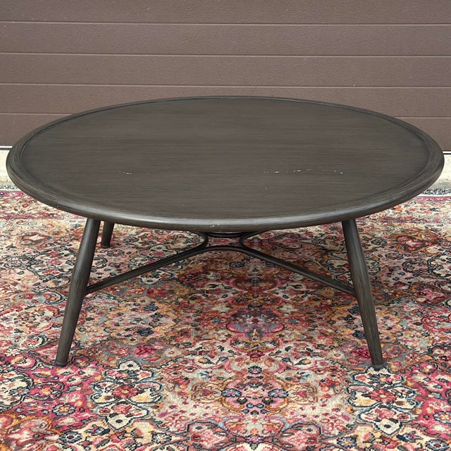 Bolano Collection by Ratana Aluminum Outdoor Round Coffee Table. Signed on underside. Bolano, this artfully hand-brushed...