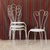 Four Mid-Century wrought iron chairs, painted white. Romantic in style, they are ideal for a patio or porch. Jean-Michel...